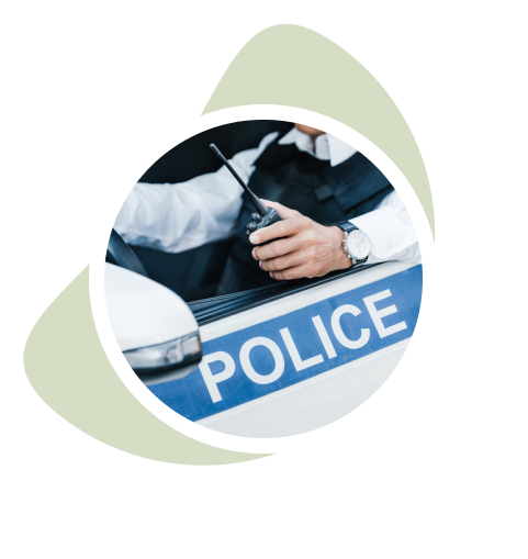 Police officer driving a police car holding a radio