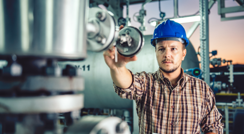 Man using tablet at Natural gas processing facility