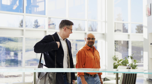 two men walking inside a smart building