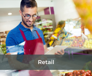 A supermarket male worker checking the inventory on fruits and vegetables